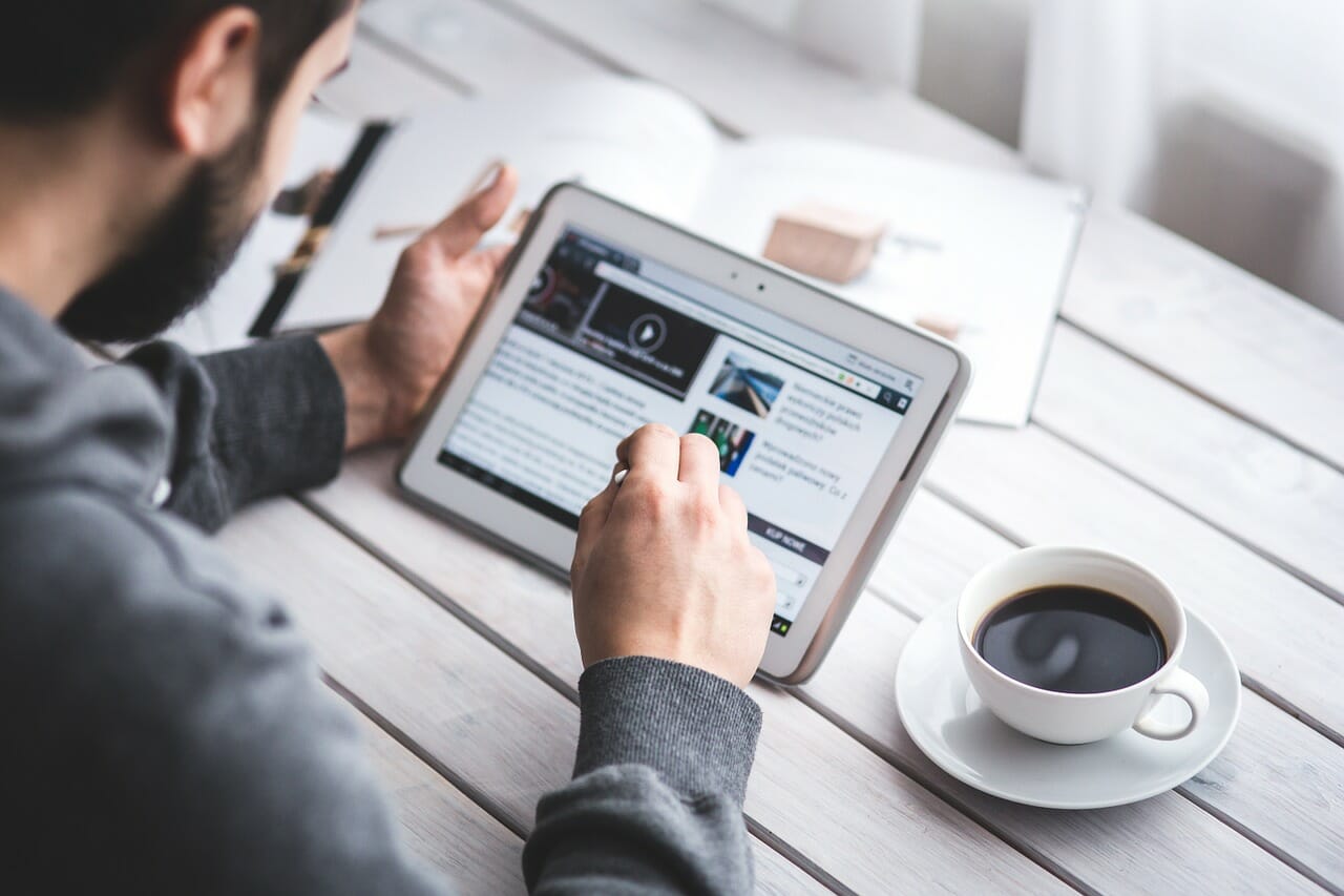 man reading tablet